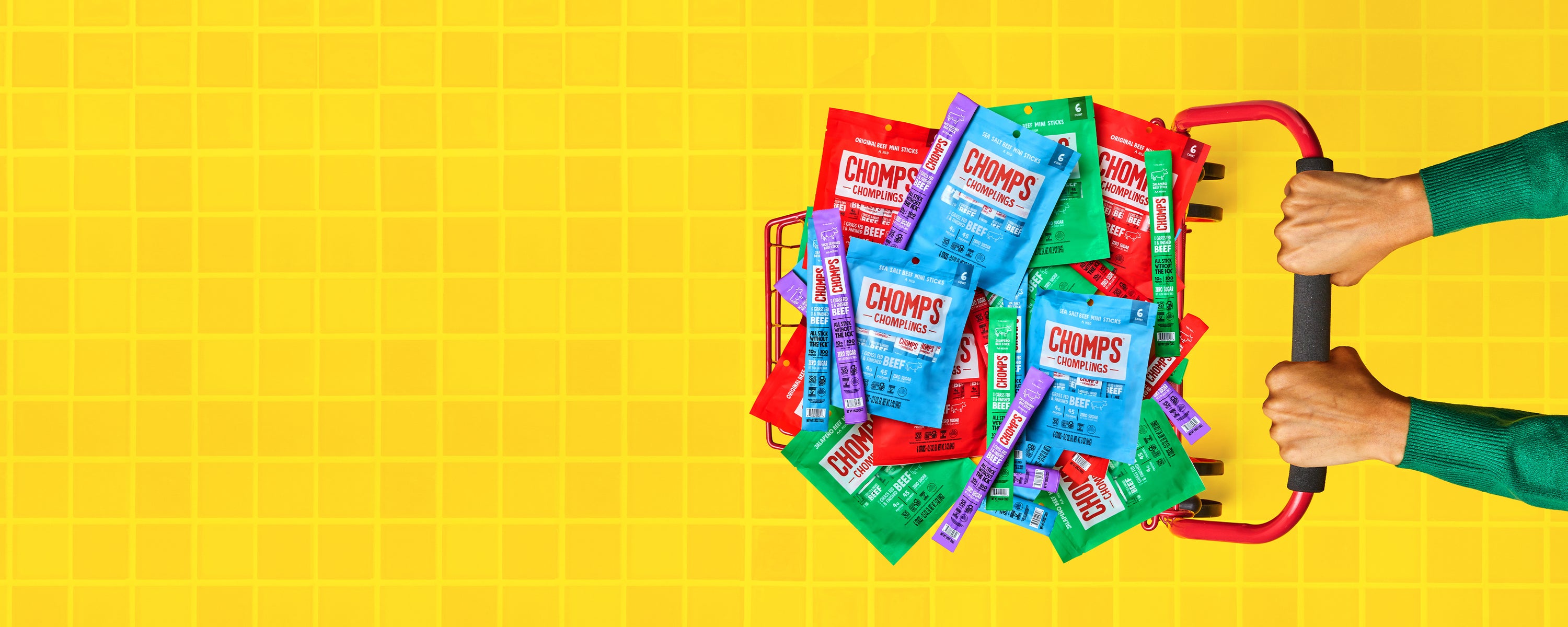 An image of a person pushing a shopping cart full of Chomps.