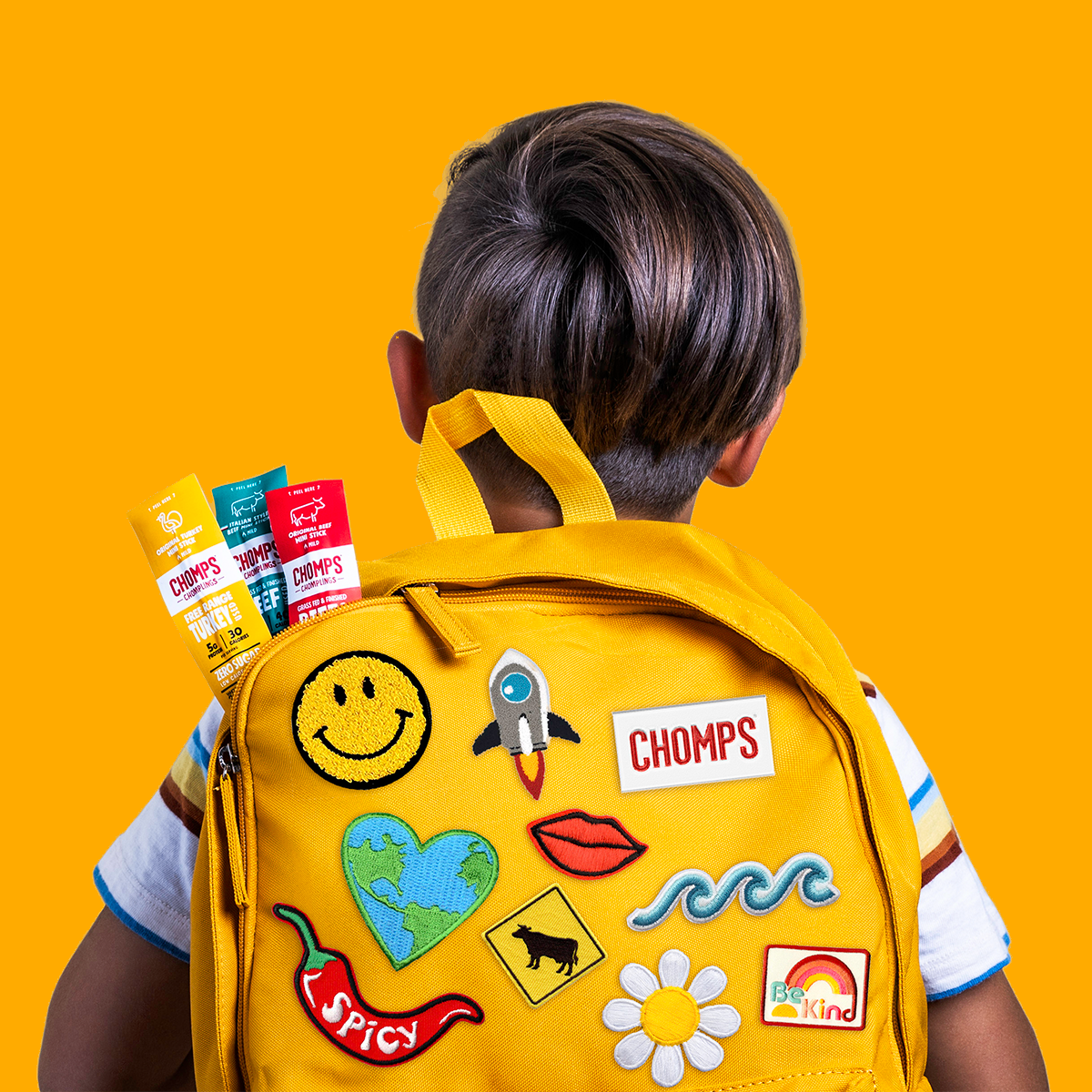 A child with a yellow backpack full of Chomps
