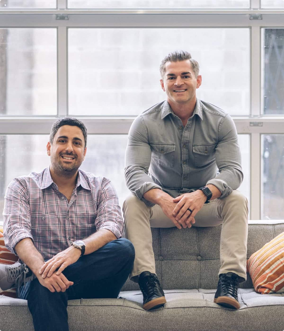 Founders Pete and Rashid sitting on a couch