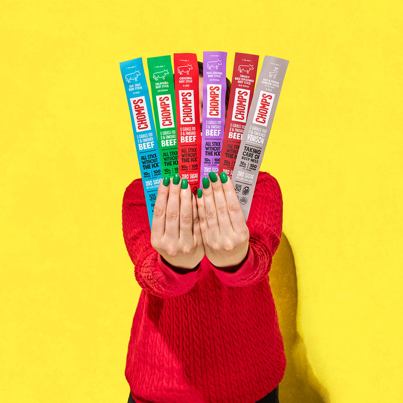 A woman holding an assortment of Chomps