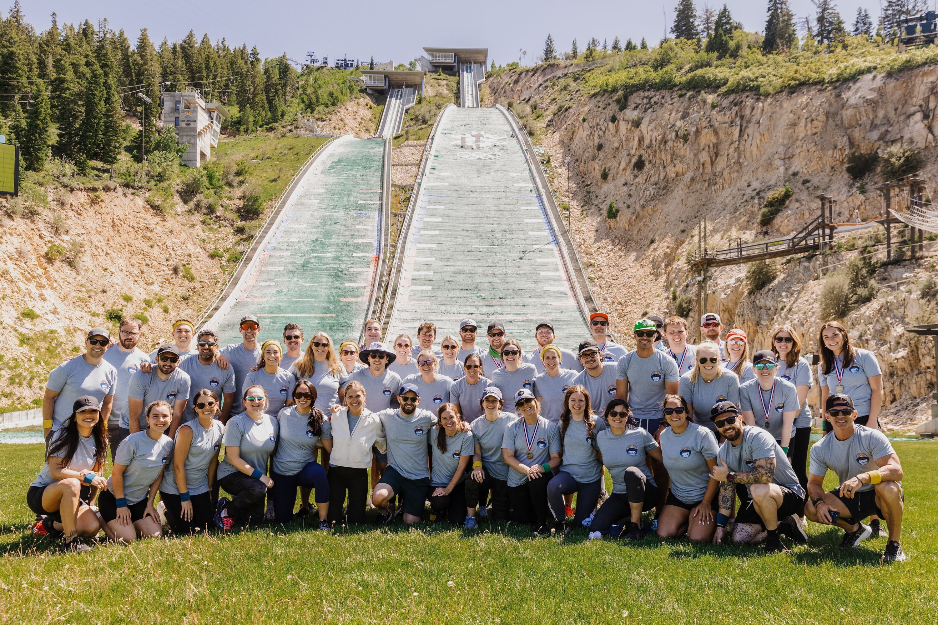 Chomps employees all lined up for a photo in front of Ski Jump in Utah during the summer